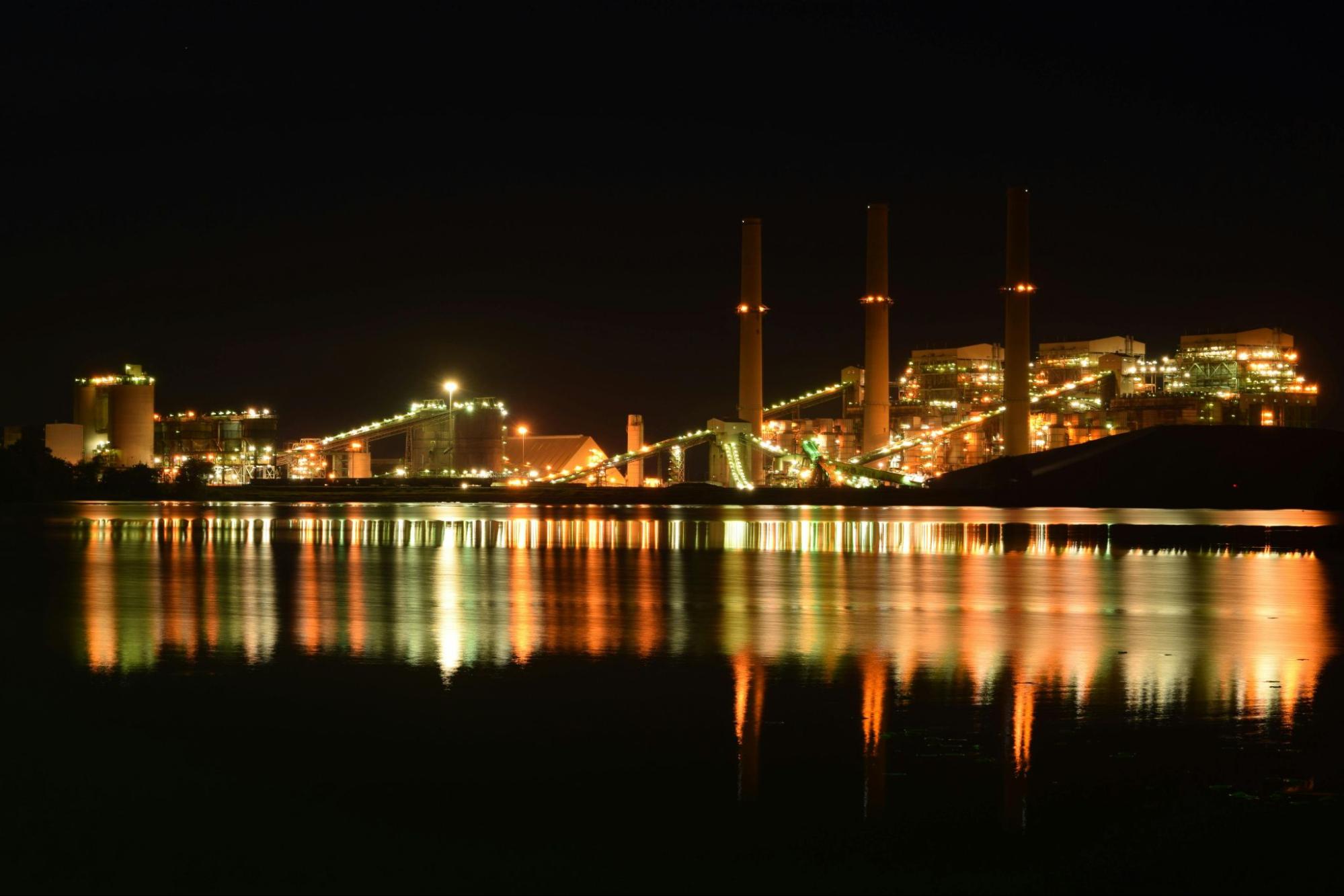 Photo of energy company along the water in the evening