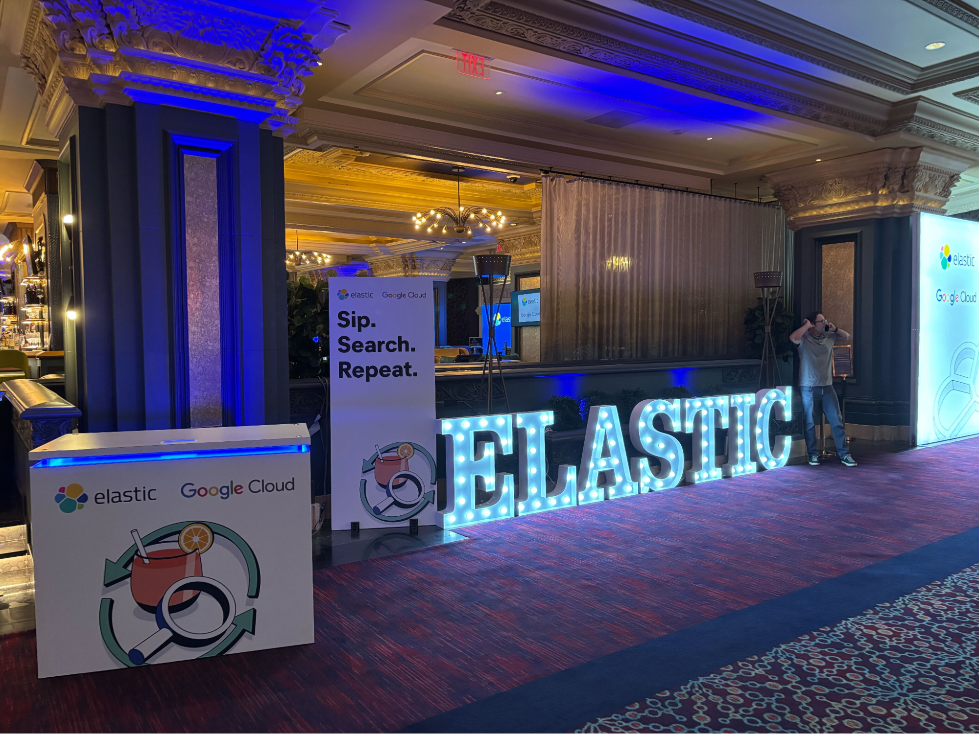 Bright marquee Elastic sign in front of a bar at Elastic's private reception