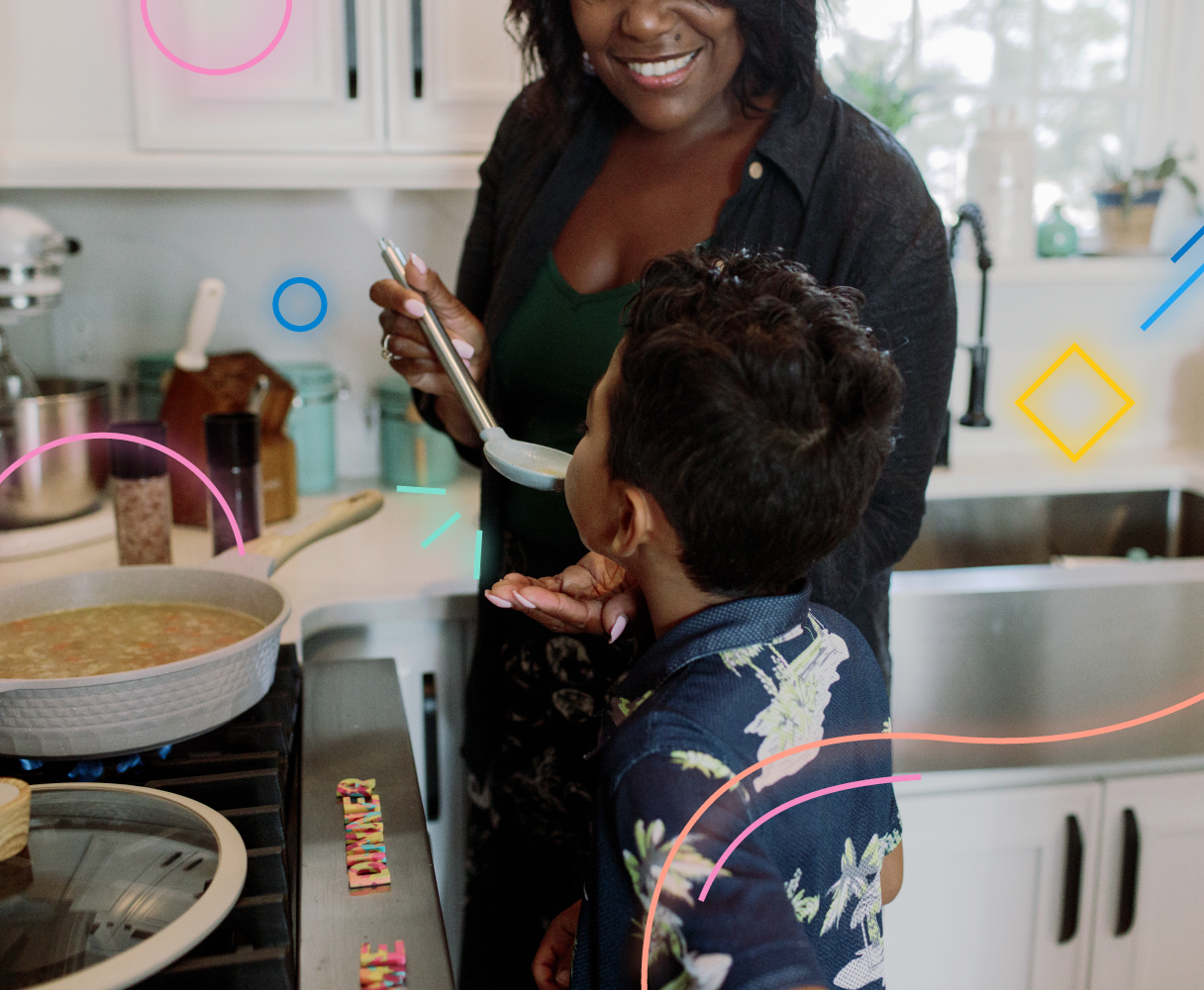 Smiling mother with work flexibility cooks with her child in kitchen