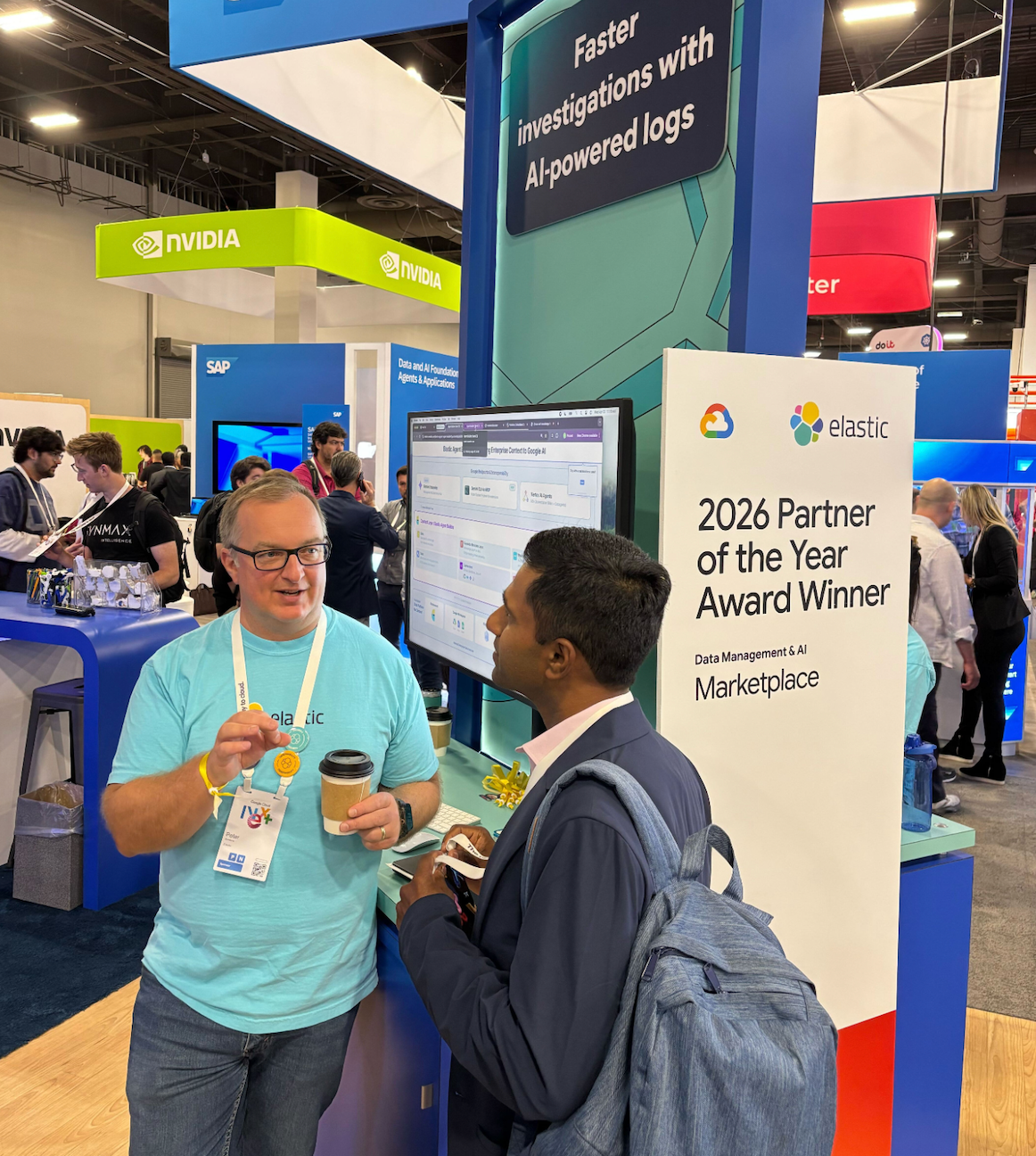 Two people chatting at the Elastic booth on the expo floor